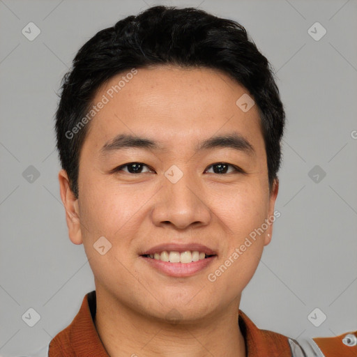 Joyful asian young-adult male with short  black hair and brown eyes