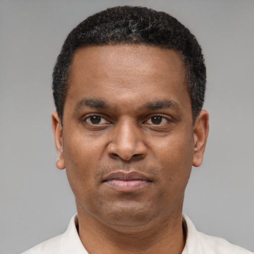 Neutral latino adult male with short  black hair and brown eyes