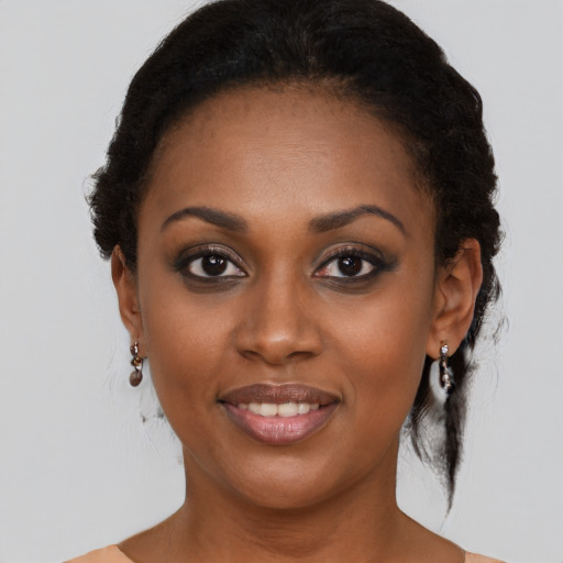 Joyful black young-adult female with medium  black hair and brown eyes