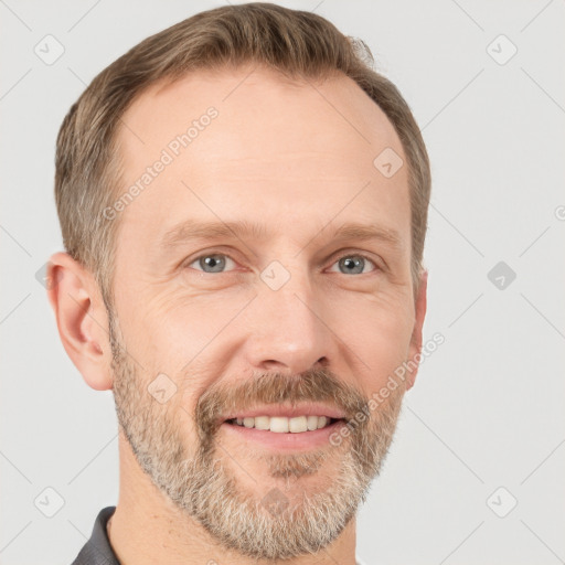 Joyful white adult male with short  brown hair and grey eyes