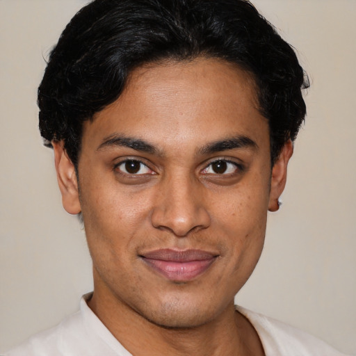 Joyful latino young-adult male with short  brown hair and brown eyes