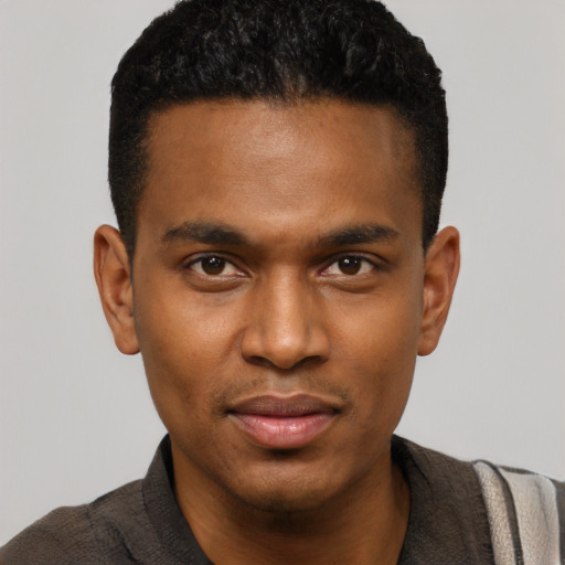 Joyful black young-adult male with short  black hair and brown eyes