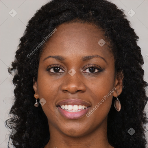 Joyful black young-adult female with long  black hair and brown eyes