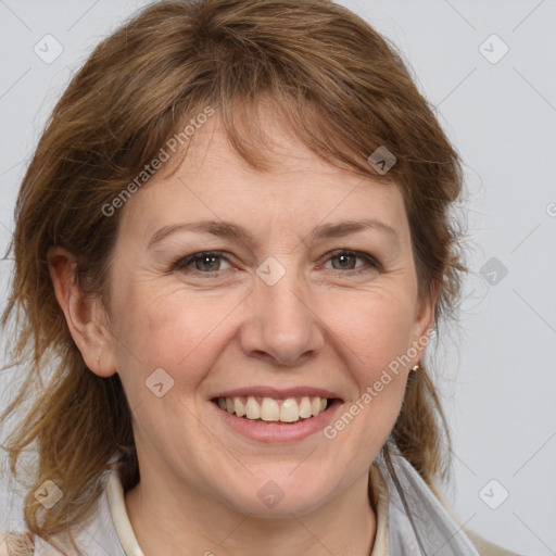 Joyful white adult female with medium  brown hair and grey eyes