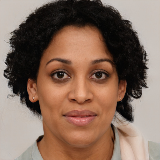 Joyful latino adult female with medium  brown hair and brown eyes