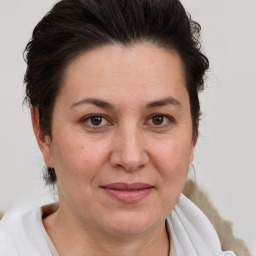 Joyful white adult female with medium  brown hair and brown eyes