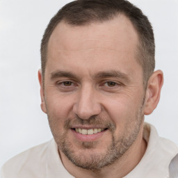 Joyful white adult male with short  brown hair and brown eyes