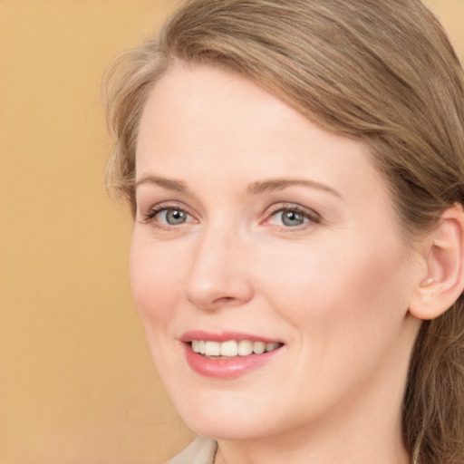 Joyful white adult female with long  brown hair and brown eyes