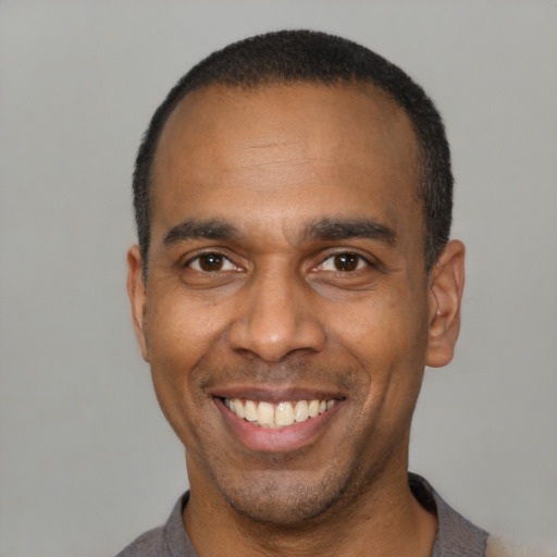 Joyful latino adult male with short  black hair and brown eyes