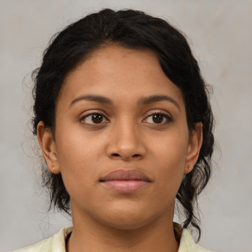 Joyful latino young-adult female with medium  brown hair and brown eyes