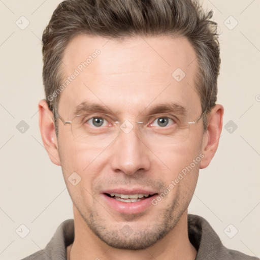 Joyful white adult male with short  brown hair and grey eyes