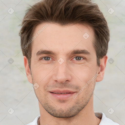 Joyful white young-adult male with short  brown hair and grey eyes