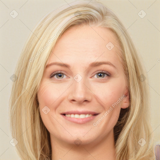 Joyful white young-adult female with long  brown hair and blue eyes