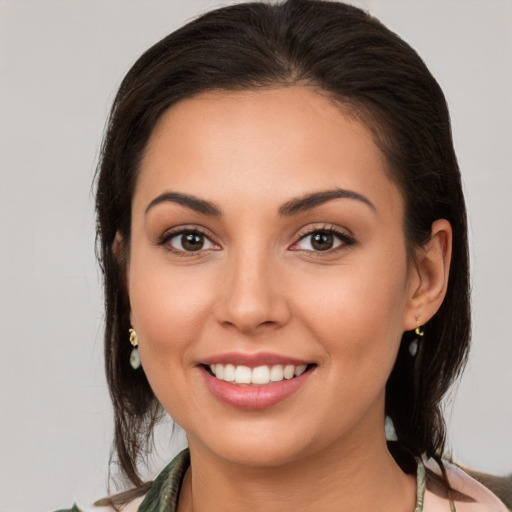 Joyful white young-adult female with medium  brown hair and brown eyes