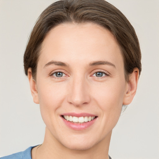 Joyful white young-adult female with short  brown hair and grey eyes