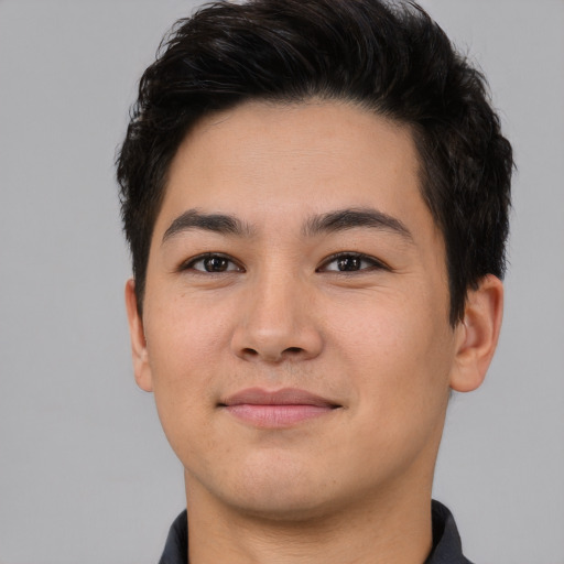 Joyful asian young-adult male with short  brown hair and brown eyes