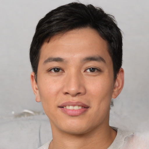 Joyful asian young-adult male with short  black hair and brown eyes