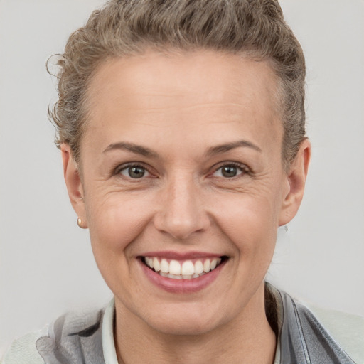 Joyful white adult female with short  brown hair and brown eyes