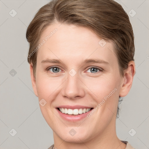 Joyful white young-adult female with short  brown hair and grey eyes