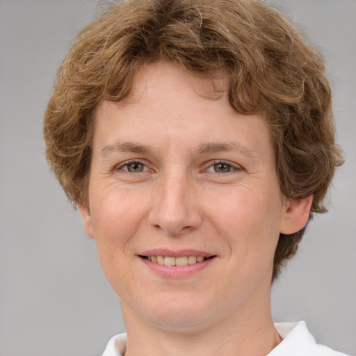 Joyful white adult female with medium  brown hair and green eyes