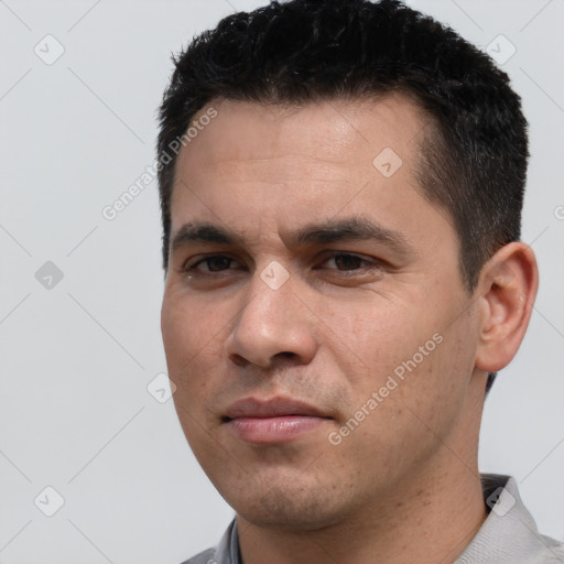 Joyful white young-adult male with short  black hair and brown eyes