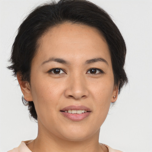 Joyful asian young-adult female with medium  brown hair and brown eyes