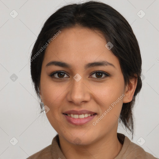 Joyful latino young-adult female with medium  brown hair and brown eyes