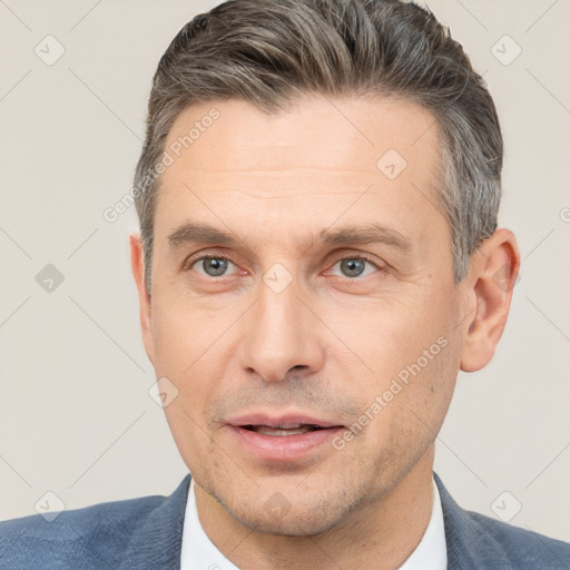 Joyful white adult male with short  brown hair and brown eyes