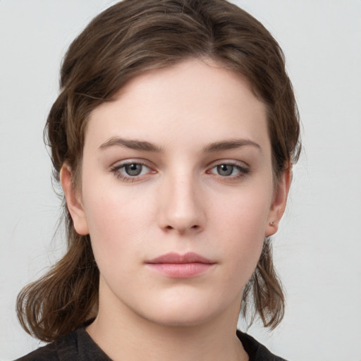 Neutral white young-adult female with medium  brown hair and grey eyes