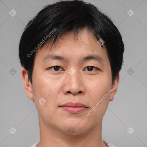 Joyful asian young-adult male with short  black hair and brown eyes