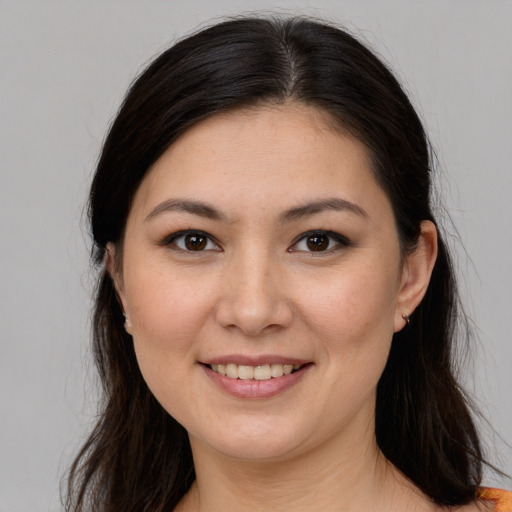 Joyful white young-adult female with long  brown hair and brown eyes