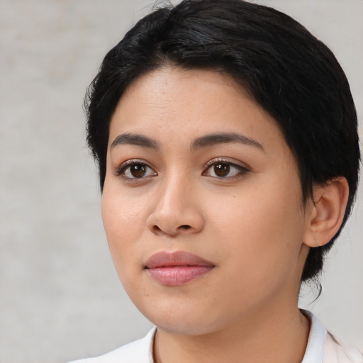 Joyful latino young-adult female with medium  black hair and brown eyes