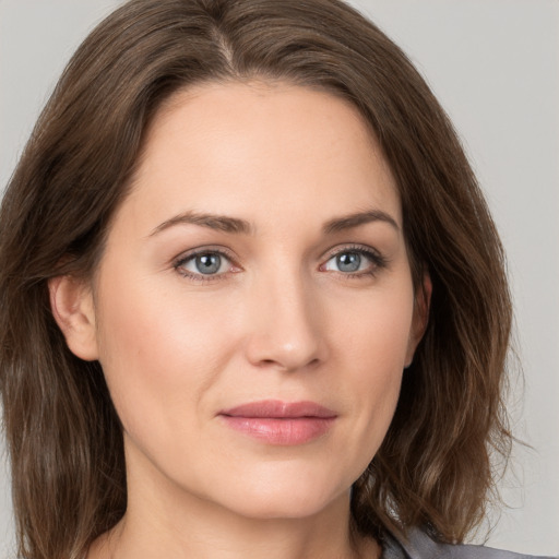 Joyful white young-adult female with medium  brown hair and green eyes