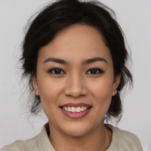 Joyful latino young-adult female with medium  brown hair and brown eyes