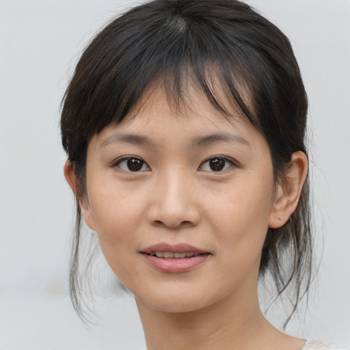 Joyful asian young-adult female with medium  brown hair and brown eyes