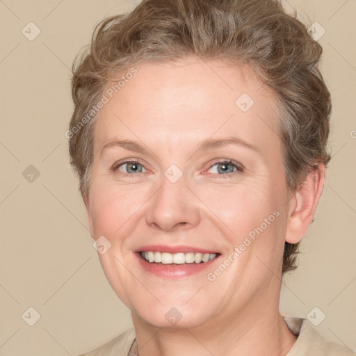 Joyful white adult female with short  brown hair and grey eyes