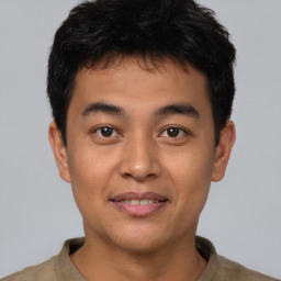 Joyful asian young-adult male with short  brown hair and brown eyes