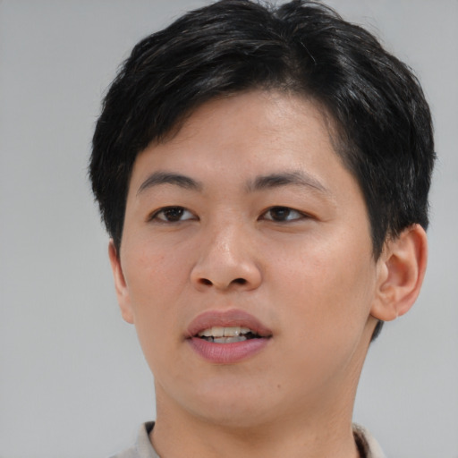 Joyful asian young-adult female with short  brown hair and brown eyes