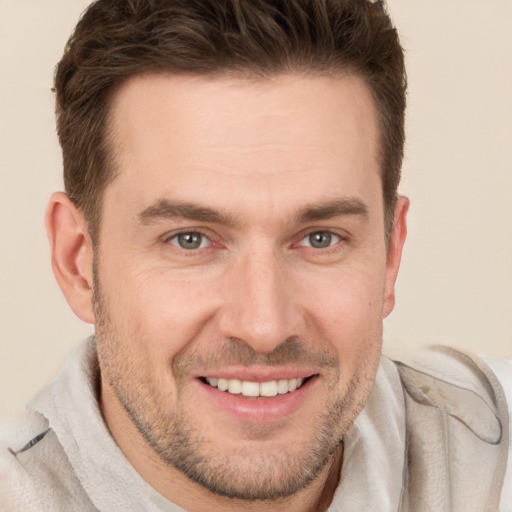 Joyful white adult male with short  brown hair and brown eyes