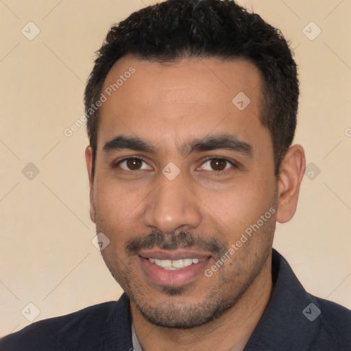 Joyful latino young-adult male with short  black hair and brown eyes