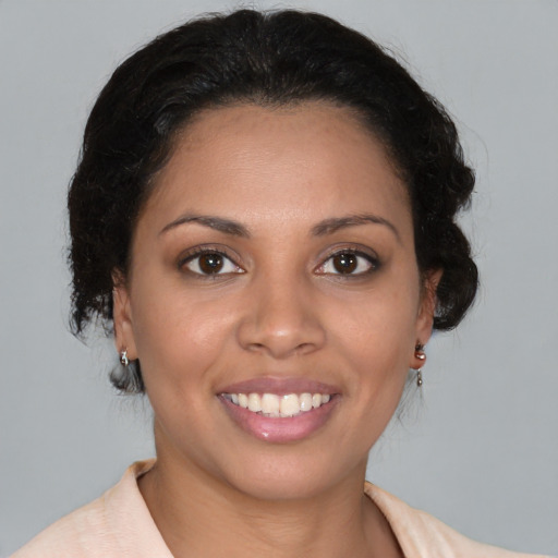 Joyful latino young-adult female with medium  brown hair and brown eyes