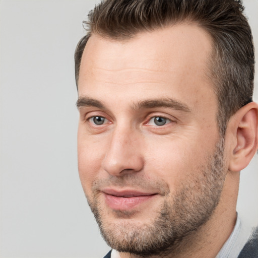 Joyful white young-adult male with short  brown hair and brown eyes