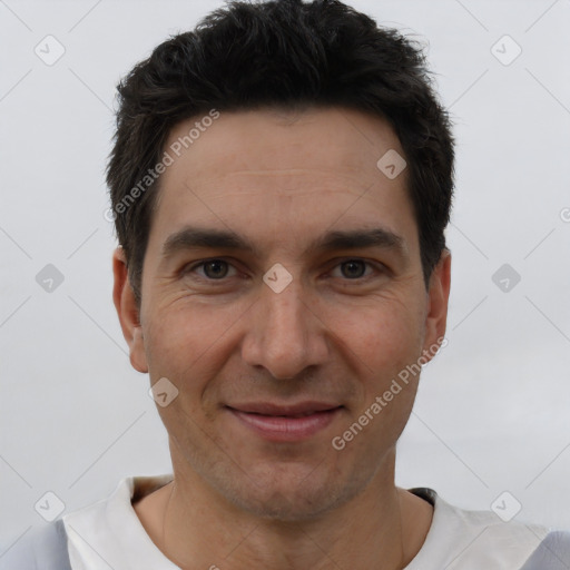 Joyful white young-adult male with short  black hair and brown eyes