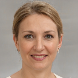 Joyful white adult female with medium  brown hair and grey eyes