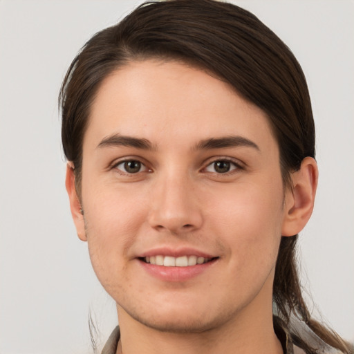 Joyful white young-adult female with short  brown hair and brown eyes