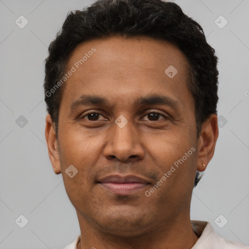 Joyful latino adult male with short  brown hair and brown eyes