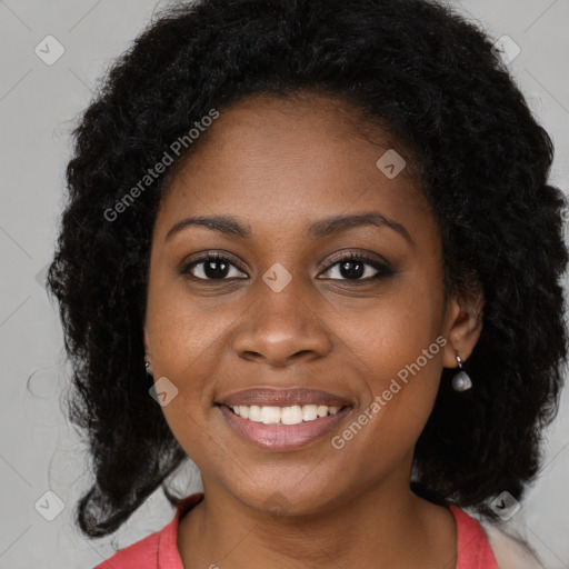 Joyful black young-adult female with long  brown hair and brown eyes