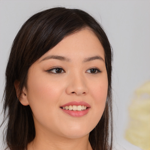 Joyful asian young-adult female with long  brown hair and brown eyes