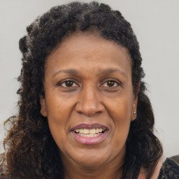 Joyful black adult female with long  brown hair and brown eyes