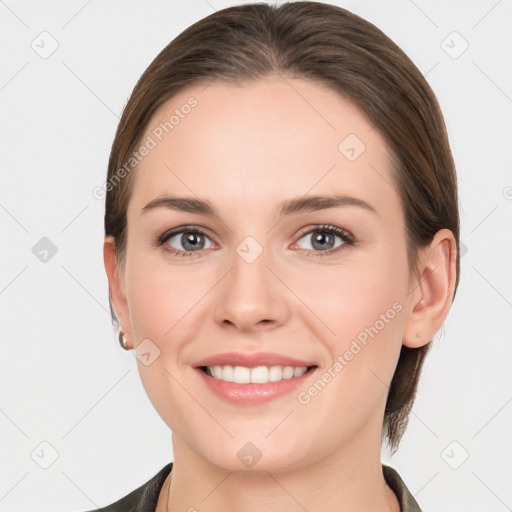 Joyful white young-adult female with medium  brown hair and grey eyes